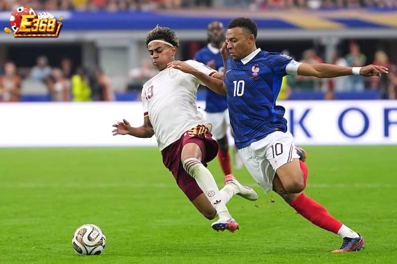 Lamine Yamal (trái) tranh bóng với Kylian Mbappe trong trận bán kết World Cup 